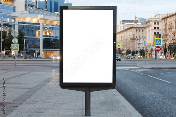 Fototapeta Vertical billboard advertising in the city. Business center with glass facade in the background. Mock-up.