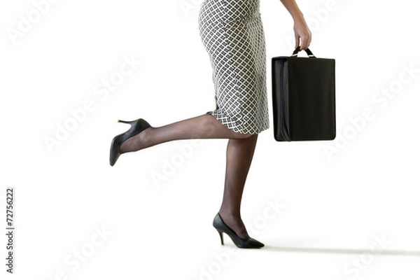Fototapeta Close up of business woman in heels carrying attache case