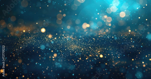 Fototapeta An abstract backdrop featuring dark blue and gold particles, with golden light emitting bokeh on a navy blue background. gold foil texture