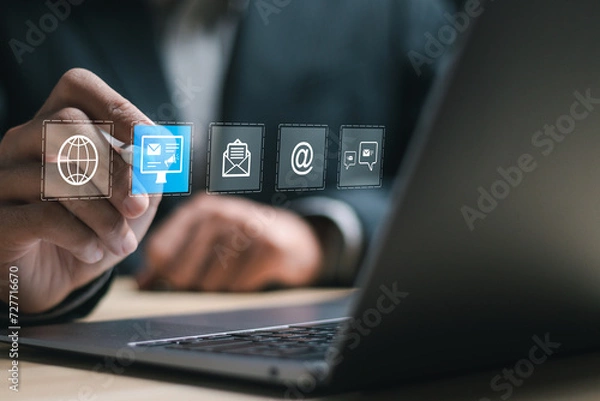Fototapeta Email marketing and newsletter advertising concept. Businessman use laptop with virtual Email marketing for business e-mail communication and digital marketing.