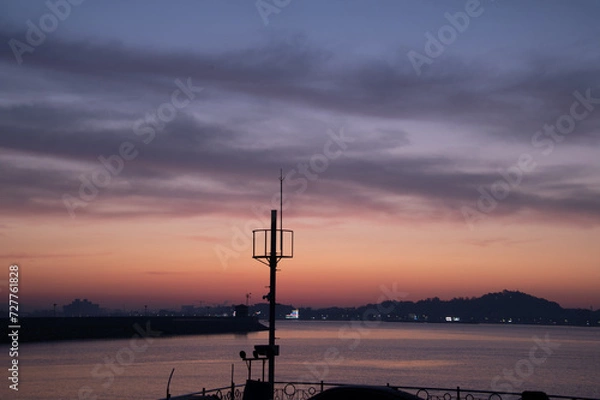 Fototapeta Scenery of a small port with a view of the dawn sky
