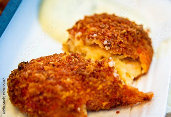 Fototapeta Closeup of half opened shrimp croquette, popular snack in Netherlands .