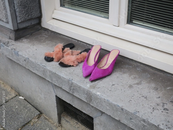 Fototapeta two pair of shoes left on the windowsill