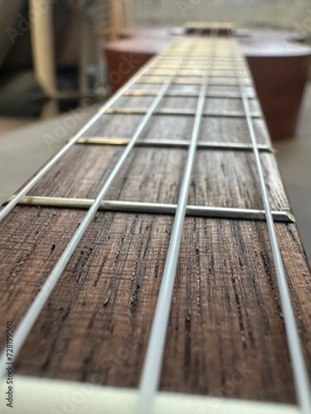 Fototapeta four strings ukulele guitar closeup on blurred background