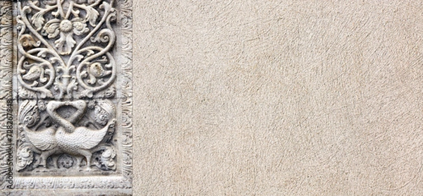Fototapeta Horizontal background with stone bas-relief with two kissing swans and floral ornament. Backdrop with sandstone carving decor. Mock up template. Copy space for text