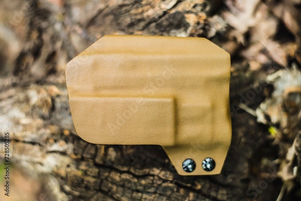 Fototapeta objective holster shooting on dry leaves in the forest