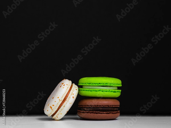 Obraz bright macaroon cookies on a black background
