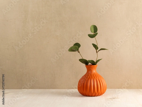 Fototapeta Green leaves branch in vase on wooden table. Copy space. Minimalist interior mock up in scandinavian style.