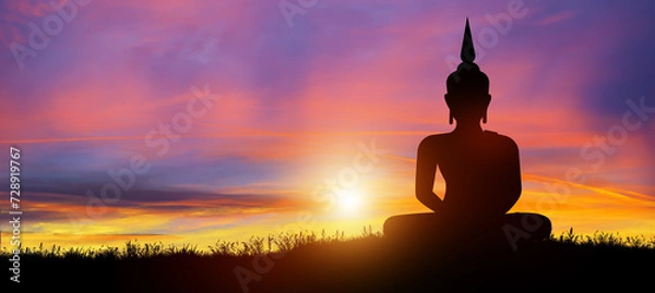 Fototapeta Silhouette of Buddha mediating in the twilight with sunrise background. Buddhist holiday Concept.