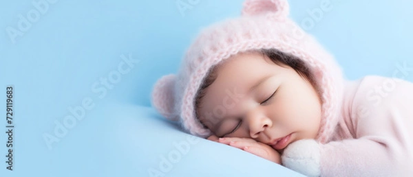 Fototapeta Newborn baby boy sleep, with empty copy space, on blue big bed
