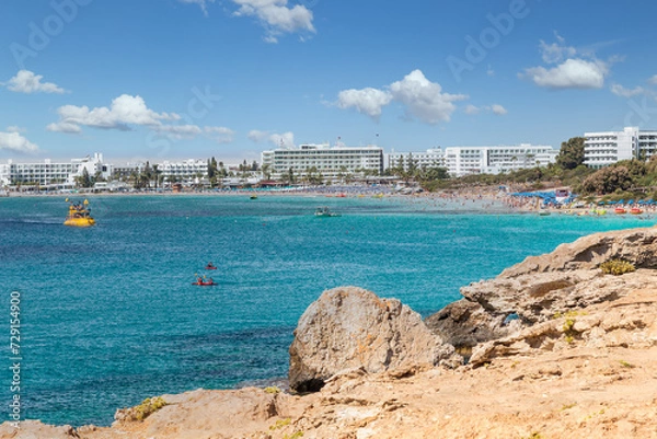 Fototapeta Vacation resort of Ayia Napa. A paradise for vacationers. A sunny day with a blue sky and white clouds. Panoramic view of the hotels and Nissi beach.