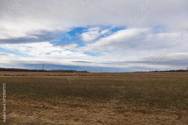 Fototapeta A beautiful lowland landscape overlooking the Palava region. Dark clouds in the sky. Fields and meadows.