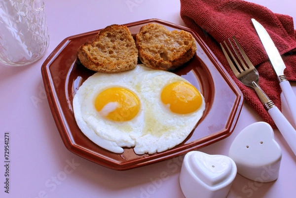 Obraz Valentine breakfast: eggs, sunny side up, with heart shaped, toasted English muffins.