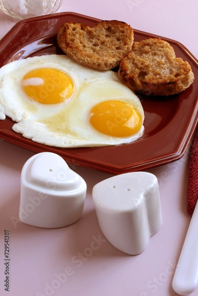 Obraz Valentine breakfast: eggs, sunny side up, with heart shaped, toasted English muffins