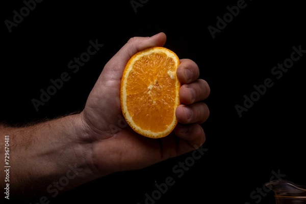 Obraz Cut squeezed orange in hand