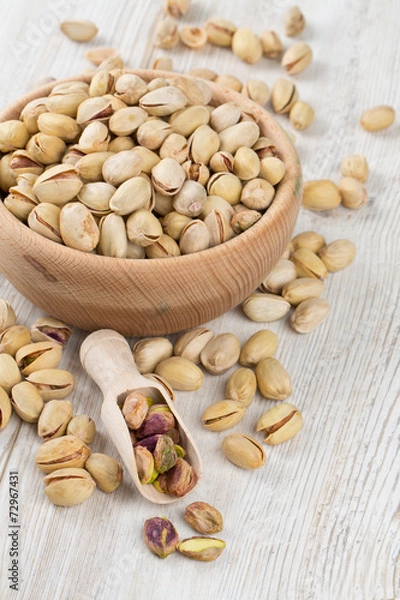 Obraz pistachios on wooden surface