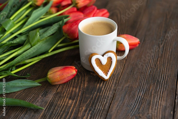 Fototapeta Fresh orange tulips and cappuccino mug with spring composition. Greeting card with copy space for Valentine's Day, Woman's Day and Mother's Day.