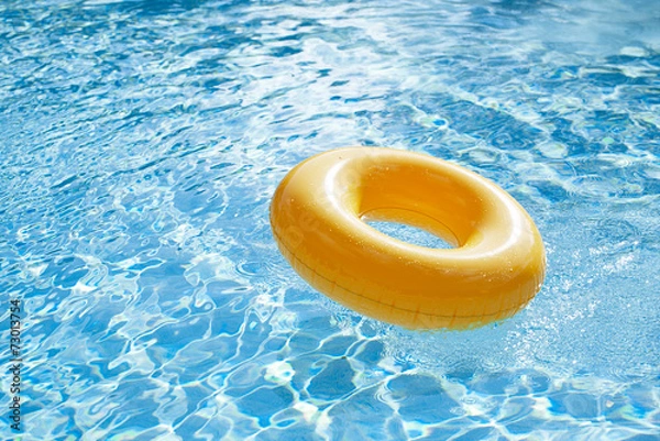 Obraz floating ring on blue water swimpool with waves reflecting