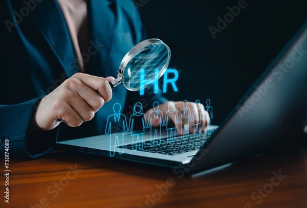 Fototapeta Human Resource Management concept. HRM. Businessman holding magnifier for searching to human icons for human development and recruitment concept. HR management. Cluster, consulting, business, people.