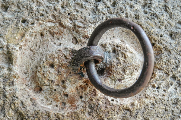 Fototapeta Old rusty door handle on a stone wall, closeup of photo