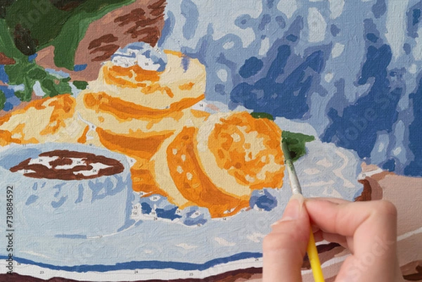 Obraz A photo of a picture that is colored by numbers in the process of coloring with a brush