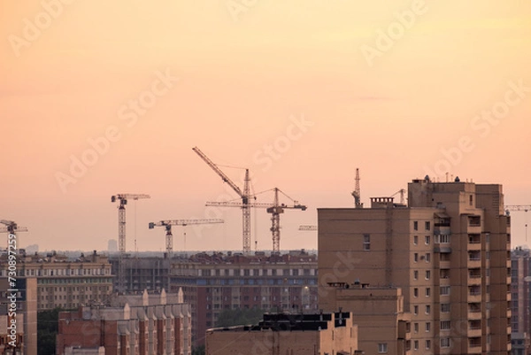 Obraz Cranes and building with evening sky background