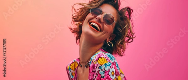 Obraz A woman wearing pink sunglasses and smiling with a vibrant pink hairpiece and bold lipstick strikes a pose in her statement sunglasses, exuding confidence and embracing her unique sense of style