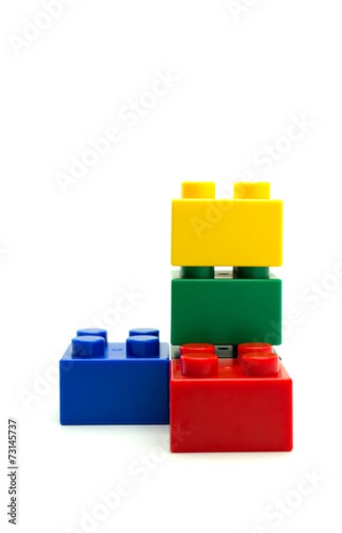 Fototapeta Plastic building blocks on white background