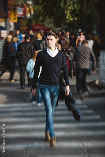 Fototapeta Young man cross the street
