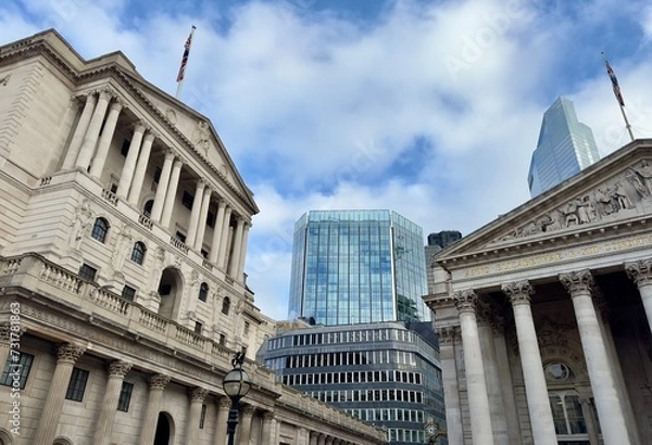 Fototapeta A partial view of the Bank of England and the Royal Exchange with modern buildings in the background skyline in the City of London, England. 