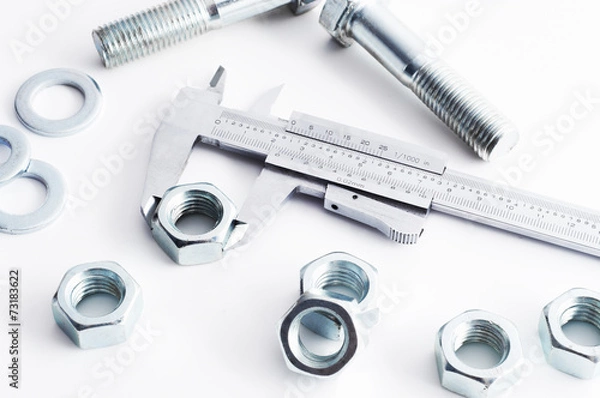 Fototapeta Measurement of steel nut. Measuring with vernier caliper