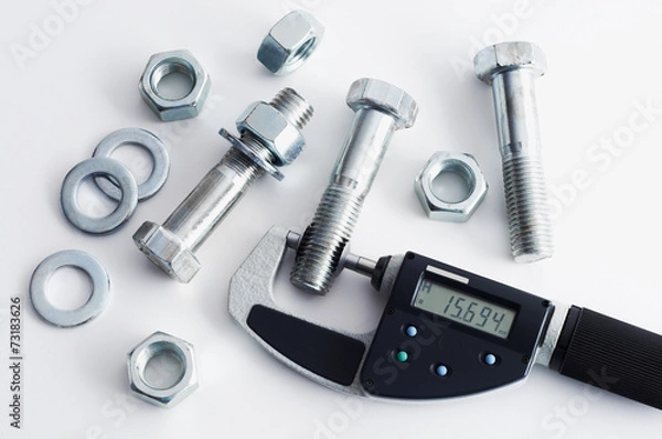 Fototapeta Measurement of steel bolts. Measuring with digital micrometer.