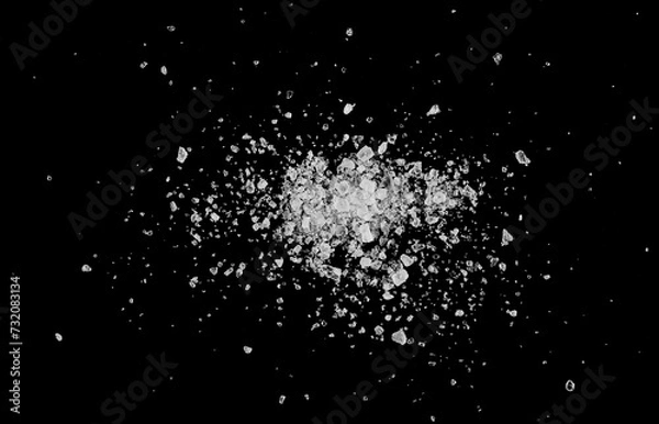 Fototapeta Close up sea ​​salt grains, crystals scattered isolated on black background, top view, macro
