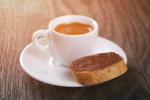 Obraz fresh espresso with baguette slice covered with chocolate cream