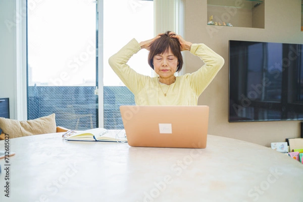 Fototapeta パソコン操作で頭をかかえるシニア女性
