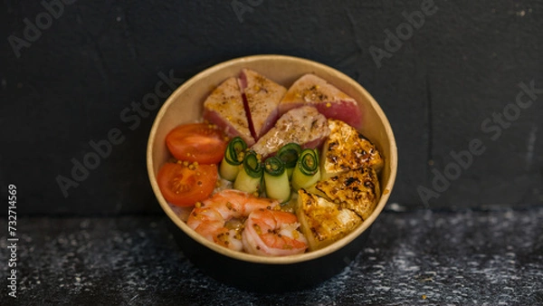 Fototapeta Seafood salad served on a beautiful plate. Salad with king prawns and prosciutto.