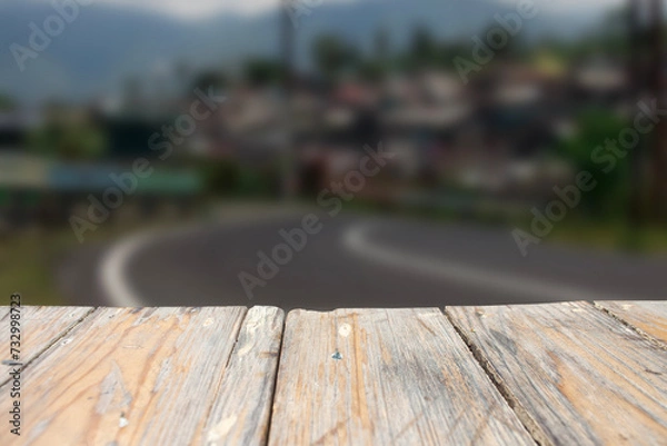 Fototapeta photo of a wooden board with a blurred street view in the background