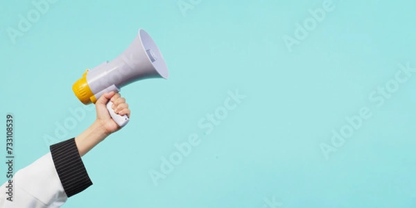 Obraz Hand hold megaphone and wear chef uniform on green mint or Tiffany Blue background.