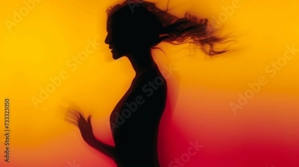 Fototapeta Female blurred silhouette on a orange background. Elegant outline of a woman in motion out of focus