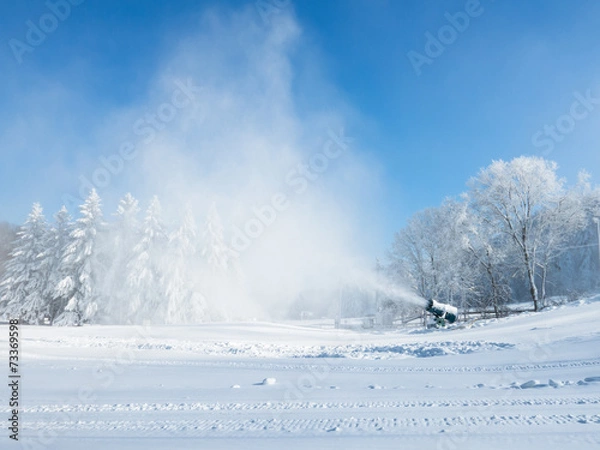 Fototapeta Working snow making machine at a ski field