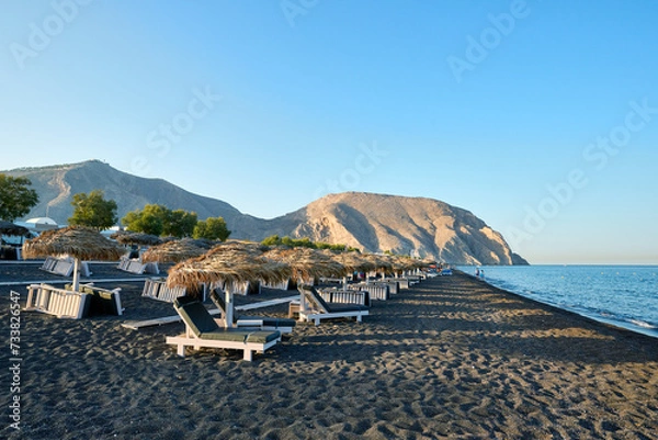 Fototapeta Perivolos beach is a characteristic beach of black sand and small dark pebbles, located in the southern part of the island of Santorini. Greek Islands, Santorini, European Vacation.