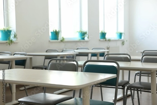 Obraz Empty school classroom with desks, windows and chairs