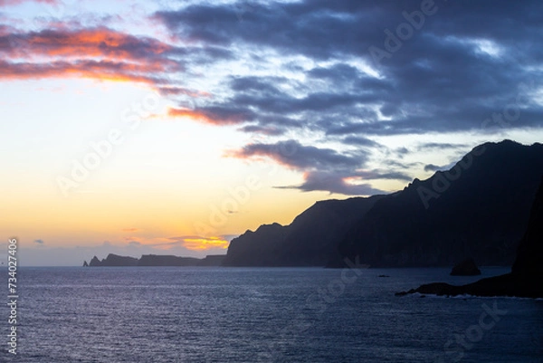Fototapeta Dawn on Ilhéu da Pocariça cliffs from the distance - Madeira, Portugal 