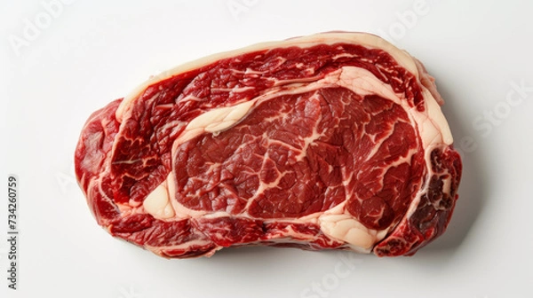 Fototapeta A close-up of a raw ribeye steak with marbling of fat, displayed on a white background.