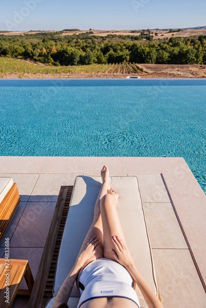 Obraz woman relaxing at the pool
