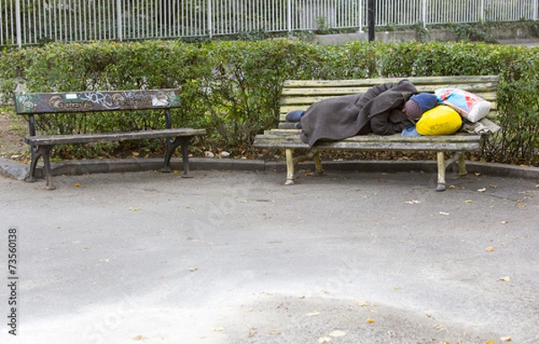 Fototapeta Bezdomny śpiący na ławce