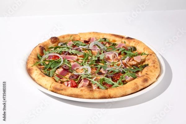 Fototapeta Gourmet tuna and olive pizza in nicoise style on a white background