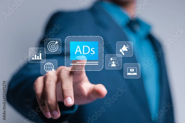 Fototapeta Digital marketing and online advertising to targeted customers. Shooting ads on cross feeds to optimize customer engagement. Businessman touch ADs icon on virtual screen.
