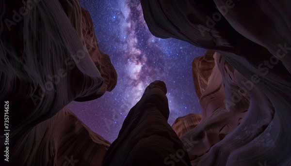 Obraz The Milky Way stretches across the night sky, visible through the dramatic and ancient rock formations of a canyon