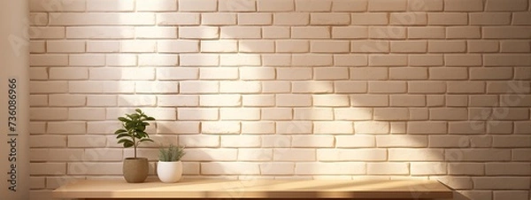 Fototapeta The wall in the room exposed to sunlight is made of ivory-colored bricks, and a flower pot with plants is placed in front of it to be used as a banner.